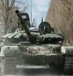 FILE PHOTO: A Ukrainian service member drives a captured Russian T-72 tank, in the recently liberated village of Lukianivka, in Kyiv region, Ukraine March 27, 2022. REUTERS/Serhii Nuzhnenko/File Photo