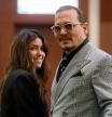 US actor Johnny Depp (R) and his attorney Camille Vasquez (L) during a break in the 50 million US dollar Depp vs Heard defamation trial at the Fairfax County Circuit Court in Fairfax, Virginia, on May 19, 2022. - Actor Johnny Depp is suing ex-wife Amber Heard for libel after she wrote an op-ed piece in The Washington Post in 2018 referring to herself as a #{emoji}147;public figure representing domestic abuse.#{emoji}148; (Photo by Shawn THEW / POOL / AFP)