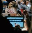 An attendee uses a mobile phone whilst looking at his laptop computer screen in the TechCrunch Disrupt London 2015 Hackathon in London, U.K., on Saturday, Dec. 5, 2015. Disrupt is an annual conference hosted by TechCrunch where some technology startups launch their products and services competing on stage in front of venture capital potential investors, media and other interested parties. Photographer: Luke MacGregor/Bloomberg