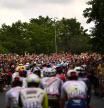TOPSHOT - A large crowd of spectators cheers as the pack of riders cycles during the 3rd stage of the 109th edition of the Tour de France cycling race, 182 km between Vejle and Sonderborg in Denmark, on July 3, 2022. (Photo by Marco BERTORELLO / AFP)