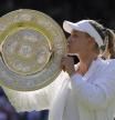 Kazakhstan's Elena Rybakina kisses the trophy as she celebrates after beating Tunisia's Ons Jabeur to win the final of the women's singles on day thirteen of the Wimbledon tennis championships in London, Saturday, July 9, 2022. (AP Photo/Kirsty Wigglesworth)