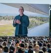 Tim Cook, chief executive officer of Apple Inc., displayed on a projection screen while speaking during the Apple Worldwide Developers Conference at Apple Park campus in Cupertino, California, US, on Monday, June 6, 2022. Apple unveiled a flurry of new software features and services including an updated iPhone lock screen and a pay-later option that pushes the tech giant deeper into finance. Photographer: David Paul Morris/Bloomberg via Getty Images