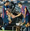 Barcelona's Spanish midfielder Sergio Busquets (L) shakes hands with Barcelona's Spanish defender Gerard Pique after being presented a red card during the Spanish league football match between FC Barcelona and Rayo Vallecano de Madrid at the Camp Nou stadium in Barcelona on August 13, 2022. (Photo by Pau BARRENA / AFP)