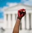 (FILES) In this file photo taken on June 25, 2022 an abortion rights demonstrator raises their fist painted in red during a rally in front of the US Supreme Court in Washington, DC. - A US federal judge blocked part of a law banning most abortions in Idaho Wednesday, a victory for US President Joe Biden's administration. The state cannot prosecute doctors who perform abortions for the sake of the pregnant woman's health, Judge B. Lynn Winmill ruled. (Photo by ROBERTO SCHMIDT / AFP)