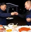 FILE PHOTO: Russian President Vladimir Putin and Chinese President Xi Jinping toast during a visit to the Far East Street exhibition on the sidelines of the Eastern Economic Forum in Vladivostok, Russia September 11, 2018. Sergei Bobylev/TASS Host Photo Agency/Pool via REUTERS/File Photo