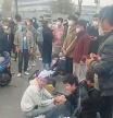 Injured workers sit on the ground during a protest outside Apple supplier Foxconn's factory in Zhengzhou, China November 23, 2022 in this still image obtained by REUTERS from a video. NO RESALES. NO ARCHIVES