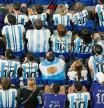 Fans wearing Argentina's Lionel Messi shirts watching the World Cup group C soccer match between Poland and Argentina at the Stadium 974 in Doha, Qatar, Wednesday, Nov. 30, 2022. Argentina won 2-0.(AP Photo/Pavel Golovkin)
