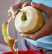 Woman Peeling Apples in Kitchen