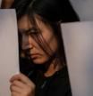 A Tibetan girl holds a white sheet of paper in a solidarity protest against China's coronavirus disease (COVID-19) lockdowns in China, in New Delhi, India December 2, 2022. REUTERS/Adnan Abidi