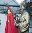 FILE PHOTO: A Chinese flag is seen next to the statue of Italian Jesuit Matteo Ricci, the first builder of church during the Ming Dynasty, at the entrance of Beijing South Catholic Church, a government-sanctioned Catholic church, in Beijing, China September 29, 2018. REUTERS/Jason Lee/File Photo