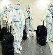 (FILES) In this file photo taken on December 3, 2021, the flight crew from Air China arrive in hazmat suits in the international terminal at Los Angeles International Airport. - The US will require negative Covid tests from all air travelers from China, saying Beijing is not sharing enough information about the surge in coronavirus cases there, health officials said on December 28, 2022. From January 5, 