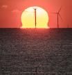 TOPSHOT - A photograph taken on December 9, 2022 shows the sun setting over an offshore wind farm, off the coast of the French Western city of Saint-Nazaire. - French MPs looked into a bill to accelerate the deployment of renewable energies at the French national Assembly on December 5, 2022. (Photo by LOIC VENANCE / AFP)
