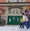 (FILES) In this file photo students walk past a public school on October 5, 2020 in the Brooklyn Borough of New York City. - New York's public schools will close temporarily to combat a rise in coronavirus cases, its mayor announced on November 18, 2020, dealing a blow to the city's recovery. Mayor Bill de Blasio said the schools would shut from Thursday 