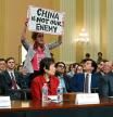 WASHINGTON, DC - FEBRUARY 28: A protester disrupts the first hearing of the U.S. House Select Committee on Strategic Competition between the United States and the Chinese Communist Party as (L-R) Scott Paul, president of the Alliance for American Manufacturing, human rights activist Tong Yi, and Lt. Gen. H.R. McCaster (Ret.) testify, at the Cannon House Office Building on February 28, 2023 in Washington, DC. The committee is investigating economic, technological and security competition between the U.S. and China. Kevin Dietsch/Getty Images/AFP (Photo by Kevin Dietsch / GETTY IMAGES NORTH AMERICA / Getty Images via AFP)