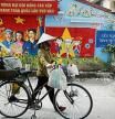 Hanoi (Vietnam), 21/10/2020.- A street vender walks past a mural on the wall in Hanoi, Vietnam, 21 October 2020. According to International Monetary Fund (IMF), Vietnam's GDP is estimated to grow at 1.6 percent in 2020. EFE/EPA/LUONG THAI LINH