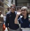 A woman waves next to Kyriakos Mitsotakis, leader of the Nea Dimokratia political party, in Athens, Greece, Saturday, June 24, 2023. Greeks return to the polls Sunday for a second general election in five weeks, with the conservative front-runners eyeing a landslide win after toppling strongholds dominated by their opponents for decades. (AP Photo/Michael Varaklas)
