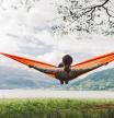 Young caucasian woman  in hammock on the background of fjord in Norway