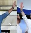 (COMBO) This combination of pictures created on July 24, 2023 shows Spanish Prime Minister and Socialist Party (PSOE) candidate for re-election Pedro Sanchez (R) and leader and candidate of conservative Partido Popular (People's Party) Alberto Nunez Feijoo waving at their headquarters in Madrid after Spain's general election on July 23, 2023. The Spanish right is only just slightly ahead of the socialists of Prime Minister Pedro Sanchez, who maintains a chance to stay in power through the game of alliances, following Spain's general election. (Photo by JAVIER SORIANO and OSCAR DEL POZO / AFP)