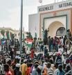 TOPSHOT - Supporters wave Nigerien's flags as they rally in support of Niger's junta in front of the National Assembly in Niamey on July 30, 2023. Niger's junta on Sunday said ECOWAS could stage an imminent military intervention in the capital Niamey as the regional body meets for an 
