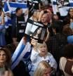 An attendee holds an image of German-Israeli woman Shani Louk, as she takes part in a 'Vigil for Israel' opposite the entrance to Downing Street, the official residence of Britain's Prime Minister, in London on October 9, 2023. (Photo by HENRY NICHOLLS / AFP)