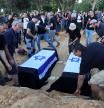 Revivim (Israel), 15/11/2023.- The coffins of Ayala Hetzroni ,73 years old and her great-niece Liel Hetzroni, 12 years old, members of kibbutz Be'Äôeri who were killed by Hamas militants on 07 October, are made ready for burial during their funeral in a temporary burial service in Kibbutz Revivim southern Israel, 15 November 2023. For security reasons, at least 26 members of Kibbutz Be'eri were buried in temporary graves in Revivim, as the Be'eri cemetery is not accessible because it is located in the closed military zone surrounding the kibbutz, which is located near the Gaza Strip. According to Jewish burial laws, and as requested by the families, the remains will be transferred to Kibbutz Be'eri when the fighting ends. More than 11,100 Palestinians and at least 1,200 Israelis have been killed, according to the Israel Defense Forces (IDF) and the Palestinian health authority, since Hamas militants launched an attack against Israel from the Gaza Strip on 07 October, and the Israeli operations in Gaza and the West Bank which followed it. (Kibutz) EFE/EPA/ABIR SULTAN
