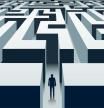 Businessman stands in front of a labyrinth. Problem solving and business opportunities. Vector illustration