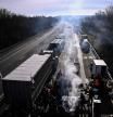 Protesting farmers gather with tractors to blockade the A16 highway, near Beauvais some hundred kilometers north of Paris, on January 28, 2024, part of a nationwide campaign of protests called by several farmers unions on pay, tax and regulations. Farmers have fumed at what they say is a squeeze on purchase prices for produce by supermarket and industrial buyers, as well as complex environmental regulations. (Photo by JULIEN DE ROSA / AFP)