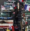 Farmers take part in a road blockage of the A6 highway near Villabe, south of Paris, on January 29, 2024, amid nationwide protests called by several farmers unions on pay, tax and regulations. Local branches of major farmer unions FNSEA and Jeunes Agriculteurs announced on January 27, 2024, a 