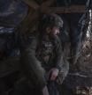 A Ukrainian soldier looks out of a shelter at the frontline in the Donetsk region, Ukraine, Sunday, Feb. 25, 2024. (Iryna Rybakova via AP)
