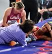 Spain's Maria Vicente (R) receives medical attention as USA's Chari Hawkins checks on her after hurting herself while competing in the Women's Pentathlon High Jump during the Indoor World Athletics Championships in Glasgow, Scotland, on March 1, 2024. (Photo by Ben Stansall / AFP)