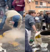 Dos jóvenes se retan en las Fallas de Valencia a dar la vuelta a una paella y el resultado es caótico: “Casi se le sale el codo”