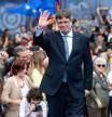Exiled Catalan separatist leader, Spanish member of the European Parliament and founder of the Junts per Catalunya (Together for Catalonia) party Carles Puigdemont waves as he gives a speech during a meeting to present his list for the upcoming regional elections in Catalonia, on April 6, 2024, in Elna, southwestern France. (Photo by Matthieu RONDEL / AFP)