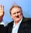 FILE PHOTO: Gerard Depardieu waves as he arrives during a red carpet event for the movie 