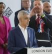 Labour Party's Sadiq Khan reacts as Britain First mayoral candidate Nick Scanlan, at right, interrupts his speech as he is re-elected for a record third time as Mayor of London, following the counting of votes, at City Hall in London, Saturday, May 4, 2024. Khan, the Labour Party's Mayor of London, has romped to victory, securing a record third straight term at City Hall, on another hugely disappointing day for the U.K.'s governing Conservatives ahead of a looming general election. (AP Photo/Alastair Grant)