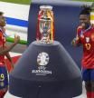 Spain's Lamine Yamal, left, and Nico Williams celebrate at the podium during the final match against England at the Euro 2024 soccer tournament in Berlin, Germany, Sunday, July 14, 2024. Spain won the game 2-1. (AP Photo/Thanassis Stavrakis)