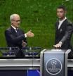 UEFA's Giorgio Marchetti directs player Cristiano Ronaldo to press a button to proceed with the Champions League, league phase, draw, in Monaco, Thursday, Aug. 29, 2024.