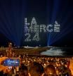 Locals and tourists look at 300 drones lighting the sky, by Flock Drone Art, on the Barceloneta beach, to mark Barcelona's patroness, La Merce, in Barcelona, Spain September 22, 2024. REUTERS/Nacho Doce