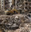 Rescuers sift through the rubble as they search for people still missing at the site of Friday's Israeli strike in Beirut's southern suburbs, Monday, Sept. 23, 2024. (AP Photo/Hassan Ammar)