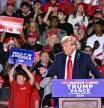 Former US President and Republican presidential candidate Donald Trump points as he speaks during a campaign rally at Huntington Place in Detroit, Michigan, October 18, 2024. (Photo by Jim WATSON / AFP)