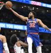 New York Knicks center Karl-Anthony Towns (32) scores over Washington Wizards forward Marvin Bagley III (35) and Wizards guard Jared Butler, right, during the second half of an NBA preseason basketball game Friday, Oct. 18, 2024, in Washington. (AP Photo/John McDonnell)