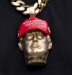 Forgiato Blow wears a necklace with a likeness of former President Donald Trump before Republican presidential nominee former President Donald Trump speaks at a campaign event at the Cobb Energy Performing Arts Centre, Tuesday, Oct. 15, 2024, in Atlanta. (AP Photo/Alex Brandon)