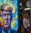 A cartoon image of US President-elect Donald Trump holding a Bitcoin token to mark the cryptocurrency reaching over $100,000 displayed at a Coinhero store in Hong Kong, China, on in Hong Kong, China, on Thursday, Dec. 5, 2024. Trump's pick of a crypto proponent to be the next head of the US securities regulator liftedBitcointo $100,000 for the first time as traders warmed to the prospect of relaxed regulations. Photographer: Justin Chin/Bloomberg