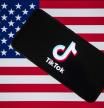 18 December 2024, India, ---: The TikTok logo is displayed on a mobile phone screen with US flag in the background. United States President-elect Donald Trump is to meet the CEO of TikTok, as the social media giant fights plans by US authorities to ban it. U.S. federal appeals court in early December upheld a law requiring Chinese-based ByteDance to divest its popular short video app TikTok in the United States by early next year or face a ban. Photo: Faisal Bashir/SOPA Images via ZUMA Press Wire/dpa