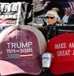 Tee shirts, hats and memorabilia supporter US President Donald Trump is for sale by a vendor who regularly sets up a street stand next to Donald Trump's star on the Hollywood Walk of Fame on January 20, 2025 as Trump's inauguration as the 47th US president. (Photo by Robyn Beck / AFP)