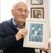 (FILES) The 99-year-old Holocaust survivor Albrecht Weinberg poses with a photo of (L-R) him, his brother Diedrich and his sister Friedel at his home in Leer (East Frisia), Germany, on December 30, 2024. Albrecht Weinberg survived the concentration camps of Auschwitz, Dora-Mittelbau and Bergen-Belsen, emigrated to the USA and returned to his homeland of East Frisia after decades as a shopkeeper in New York. (Photo by FOCKE STRANGMANN / AFP)