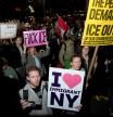 SENSITIVE MATERIAL. THIS IMAGE MAY OFFEND OR DISTURB. People hold signs during a protest against Immigration and Customs Enforcement (ICE) outside the U.S. Immigration Court in Manhattan, New York City, U.S. October 22, 2025. REUTERS/Angelina Katsanis