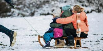 BERLIN, GERMANY - JANUARY 30: Children enjoy snow day on slides during the second wave of the coronavirus pandemic on January 30, 2021 in Berlin, Germany. Authorities extended the current hard lockdown till February 14 as daily Covid-19 infection rates and deaths remain high. (Photo by Maja Hitij/Getty Images)