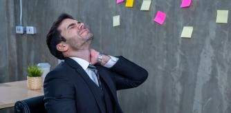 A business man suffering from pain in the neck.