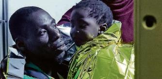 Rescued migrants disembark from a boat on the Italian island of Lampedusa during the evening of Saturday, Sept. 16, 2023. Tensions on the small island were rising Saturday, as both residents and migrants chafed at the long wait times to transfer people from the crowded reception center to the Italian mainland. Nearly 7,000 migrants arrived on Lampedusa from Tunisia this week, and the Red Cross said that 3,800 remained on the island on Friday. (Cecilia Fabiano/LaPresse via AP)