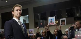 With people holding photos of their loved ones in the audience, Meta CEO Mark Zuckerberg arrives to testify before a Senate Judiciary Committee hearing on Capitol Hill in Washington, Wednesday, Jan. 31, 2024, to discuss child safety. (AP Photo/Susan Walsh)